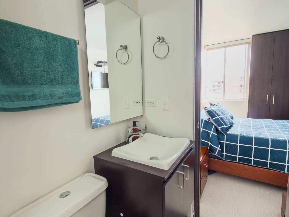 Baño con mueble bajo lavamanos y espejo.